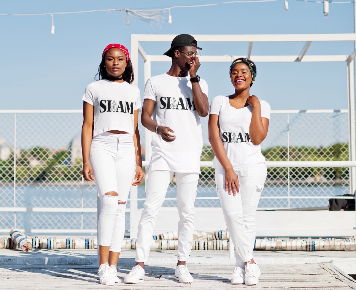 Three models wearing white SIAM apparel outdoors